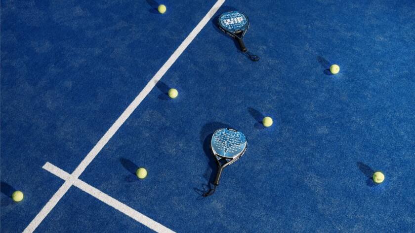 Padel vs tennis — rackets and balls on a padel court